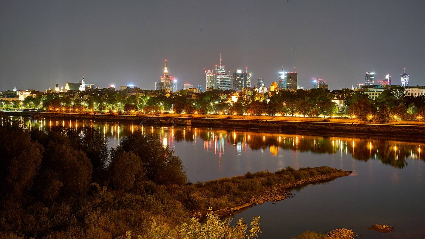 Warsaw skyline at night over the Vistula